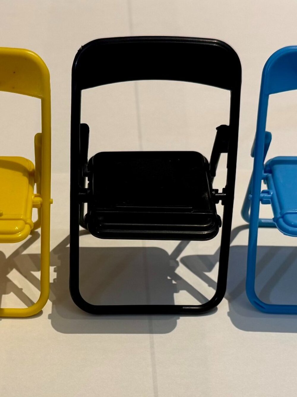 Black Plastic Folding Chair Cell Phone Stand